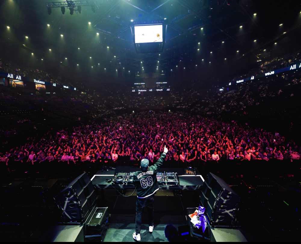 DJ face à la foule d'une grande salle de concert